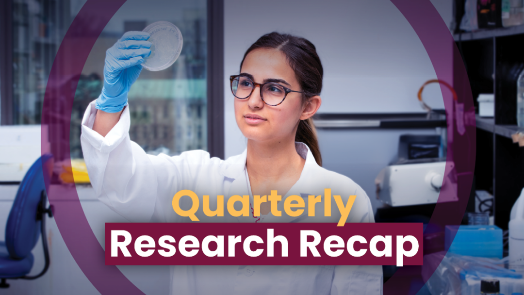 A young adult researcher in a white lab coat stands in a research laboratory visually examining a petri dish in their right hand. The text, ‘Quarterly Research Recap’, is seen in front of them, and the researcher is highlighted by a maroon circle.